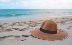 Stylish Beach Hat On Seashore Wallpaper