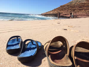 Stylish Beach Sandals On Tropical Beach Side Wallpaper