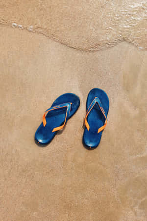 Stylish Beach Sandals On Vibrant Shore Wallpaper