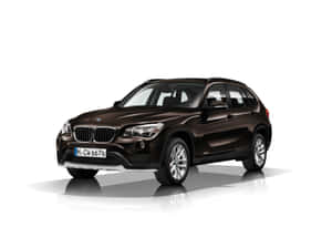 Stylish Bmw X1 In Motion On A Stunning Scenic Route Wallpaper