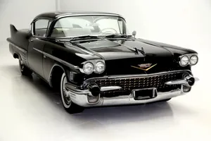 Stylish Cadillac Deville Cruising The Streets Wallpaper