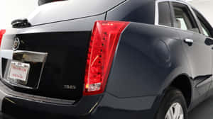 Stylish Cadillac Srx On The Road Wallpaper