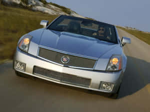 Stylish Cadillac Xlr Cruising On The Road Wallpaper