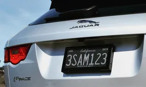 Stylish Car License Plate On A Vibrant Red Vehicle Wallpaper