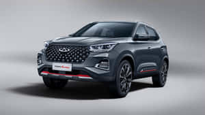 Stylish Chery Car In Vibrant Setting Wallpaper