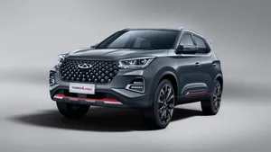 Stylish Chery Car In Vibrant Setting Wallpaper