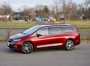 Stylish Chrysler Pacifica Parked On A Modern Driveway Wallpaper