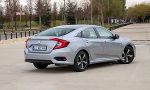 Stylish Compact Car In Motion Wallpaper