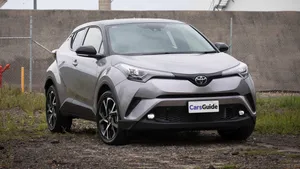 Stylish Compact Car On An Urban Road Wallpaper