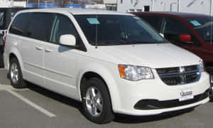 Stylish Dodge Grand Caravan On The Road Wallpaper