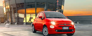 Stylish Fiat 500 Parked On A City Street Wallpaper