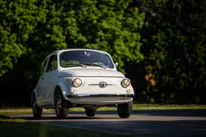 Stylish Fiat 500 Parked On A City Street Wallpaper