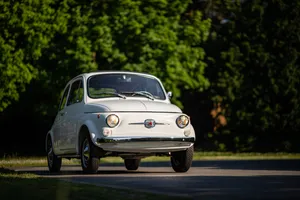 Stylish Fiat 500 Parked On A City Street Wallpaper