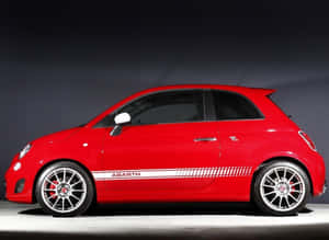 Stylish Fiat 500l Cruising On Urban Streets Wallpaper