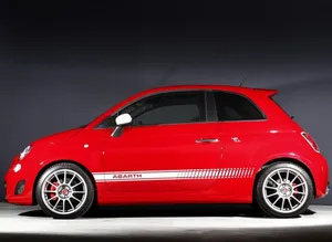 Stylish Fiat 500l Cruising On Urban Streets Wallpaper