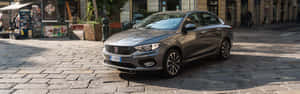 Stylish Fiat Tipo Cruising Through The City Streets Wallpaper