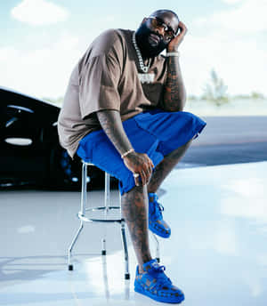 Stylish_ Figure_ Sitting_ With_ Sunglasses Wallpaper