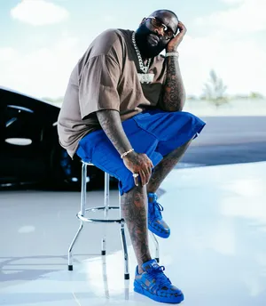 Stylish_ Figure_ Sitting_ With_ Sunglasses Wallpaper