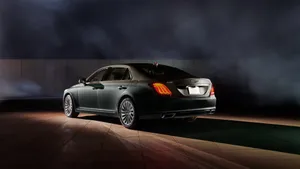 Stylish Genesis G70 Driving Through City Streets Wallpaper