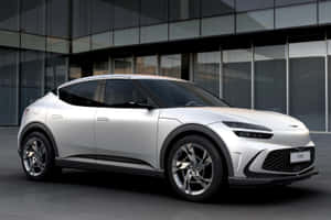 Stylish Genesis Gv60 Electric Suv On The Road Wallpaper