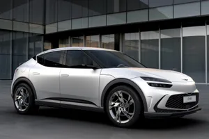 Stylish Genesis Gv60 Electric Suv On The Road Wallpaper