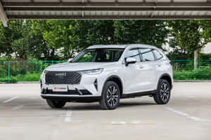 Stylish Haval Suv Cruising On A Scenic Highway Wallpaper