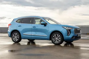 Stylish Haval Suv Driving Through The Majestic Mountain Landscape Wallpaper