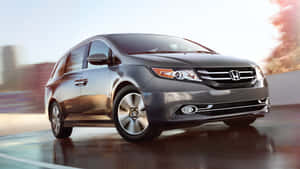 Stylish Honda Odyssey Cruising On The Open Road Wallpaper