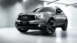 Stylish Infiniti Qx70 Cruising On The Road Wallpaper