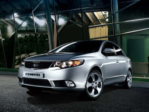 Stylish Kia Forte On An Open Road Wallpaper