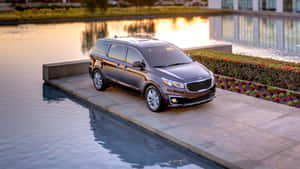 Stylish Kia Sedona Minivan On The Road Wallpaper