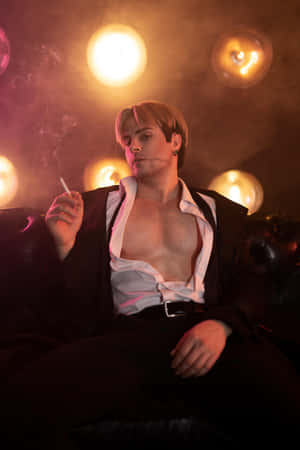 Stylish_ Man_ Smoking_ Under_ Warm_ Lights Wallpaper