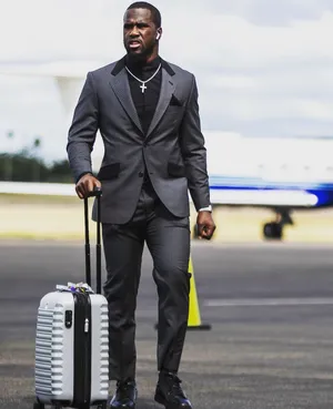 Stylish Man Walking With Suitcase Wallpaper