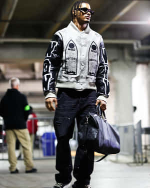 Stylish Man Walkingwith Duffle Bag Wallpaper