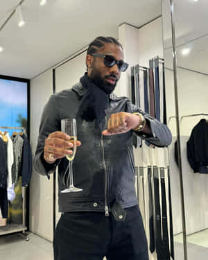 Stylish Man With Champagnein Boutique Wallpaper