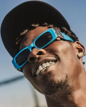 Stylish Man With Grillzand Sunglasses Wallpaper