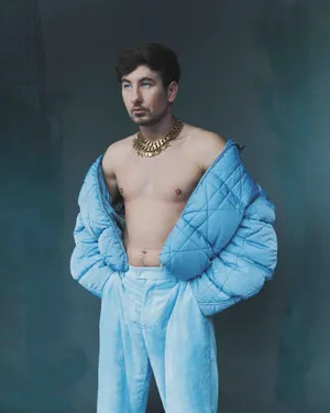 Stylish Manin Blue Puffer Jacketand Gold Necklace Wallpaper