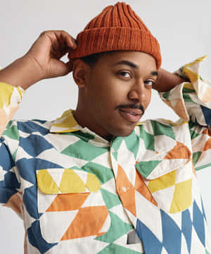 Stylish Manin Orange Beanieand Colorful Shirt Wallpaper