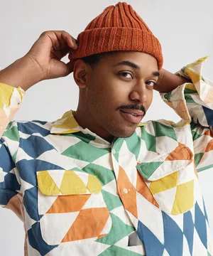 Stylish Manin Orange Beanieand Colorful Shirt Wallpaper