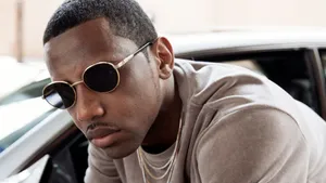 Stylish Manwith Sunglasses Leaningon Car Wallpaper