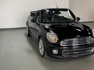Stylish Mini Cooper Convertible Cruising Down The Street Wallpaper