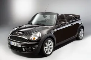 Stylish Mini Cooper Convertible Cruising In The City Wallpaper