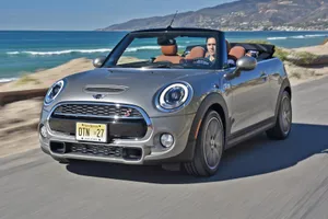 Stylish Mini Cooper Convertible Cruising On The Open Road Wallpaper