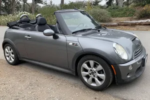 Stylish Mini Cooper Convertible Cruising On The Road Wallpaper