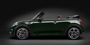 Stylish Mini Cooper Convertible Cruising The City Wallpaper