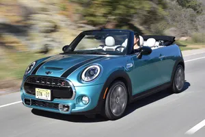 Stylish Mini Cooper Convertible Cruising The Streets Wallpaper