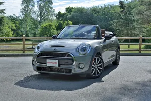 Stylish Mini Cooper S Convertible Cruising Down The Road Wallpaper