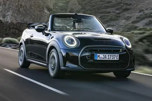 Stylish Mini Cooper S Convertible Cruising On The Open Road. Wallpaper