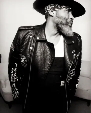 Stylish Music Artistin Leatherand Hat Wallpaper