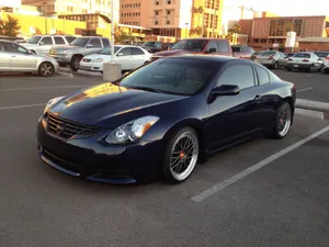 Stylish Nissan Altima In Cityscape Wallpaper